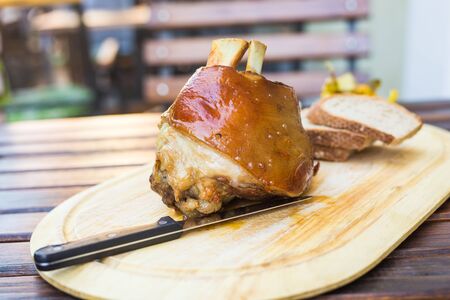 Roasted knuckle of pork on wooden board.の写真素材