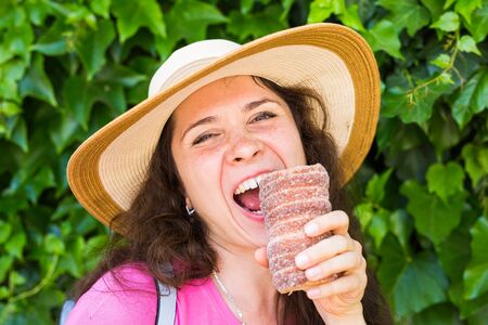 Close-up of young female tourist with traditional czech dessert trdelnik in Prague. Czech Republic....