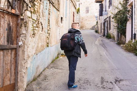 Young hipster man traveling backpacker outdoor. Travel concept.