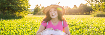cute funny laughing or surprised woman with freckles in hat