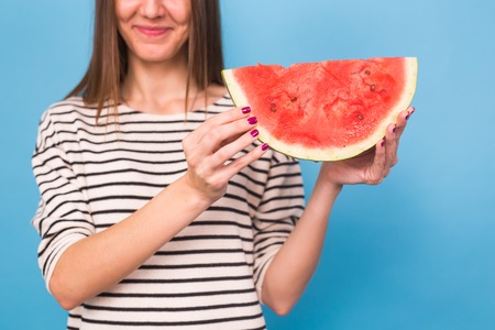 Summer, vacation, diet and vegans concept - Beautiful smiling young woman holding watermelonの写真素材