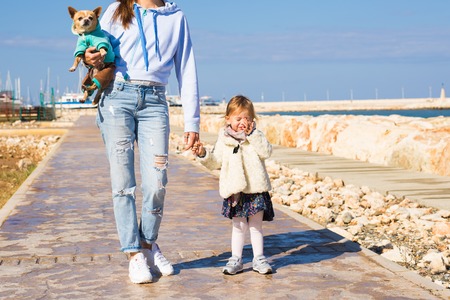 Mother and her daughter walks on the beachの写真素材