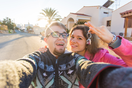 New homeowners with key. Real estate, new house or apartment and people conceptの写真素材