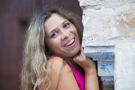 Outdoors portrait of beautiful young girl laughingの写真素材