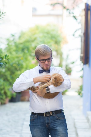 Red cat in the hands of stylish manの写真素材