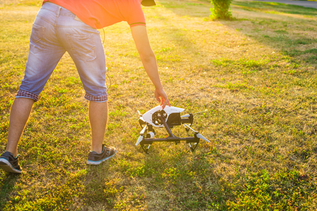 Ufa, Russia. - August 8, 2016: White drone, quadrocopter with photo camera flying in the blue sky.のeditorial素材