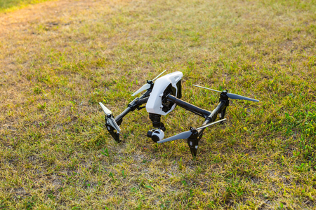 Ufa, Russia. - August 8, 2016: White drone, quadrocopter with photo camera flying in the blue sky.のeditorial素材