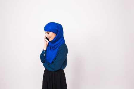 beautiful young arabian woman talking on cell phone.の写真素材