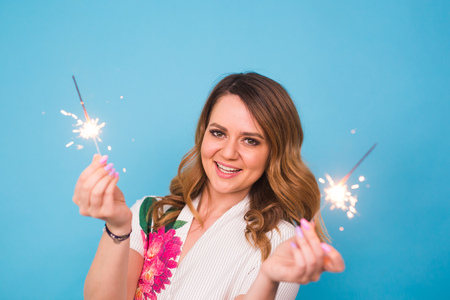 Woman Sparkler Celebration Happiness Firework Concept on blue background.の写真素材