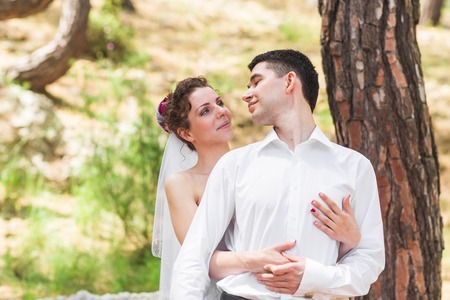 Bride and groom on a romantic moment on nature. Stylish wedding couple outdoorsの写真素材