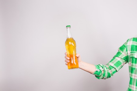 Beer bottle in the hand on white background.の写真素材