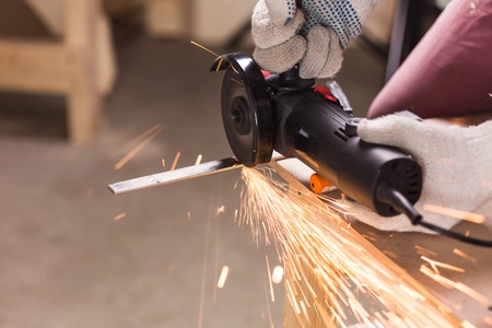 Angel grinder make a flash sparks. cutting metal with angle grinder, sparks from the disk.の写真素材