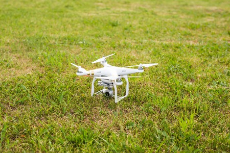 White drone, quadrocopter with photo camera flying in the blue skyのeditorial素材