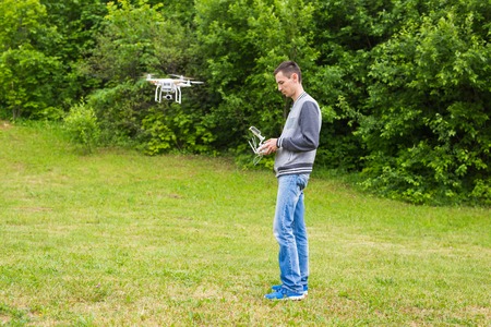 White drone, quadrocopter with photo camera flying in the blue skyのeditorial素材