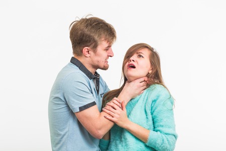 domestic violence, abuse and people concept - man beating woman on white background
