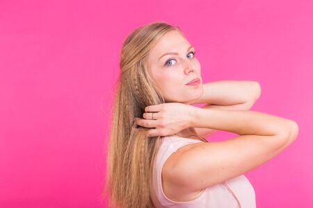 Fashion blonde over pink background. Woman portrait.の写真素材