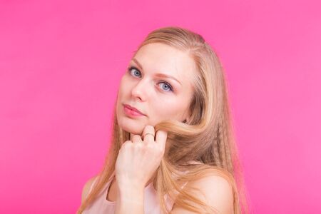 Close up portrait of a confident young blond woman smilingの写真素材