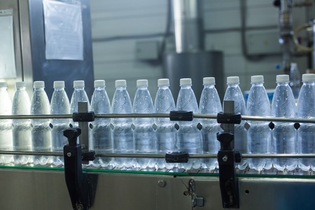 Plastic water bottles on conveyor and water bottling machine industry.の写真素材