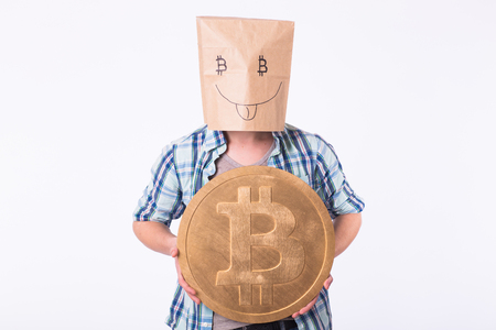 Golden Bitcoin in a funny man hand, Digitall symbol of a new virtual currency.の写真素材