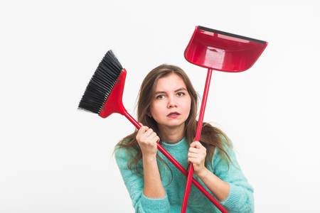 Woman or housewife holding broom, tired to cleaning, on white background, isolated with copy space.の写真素材