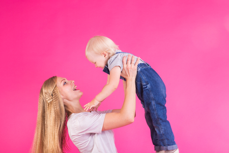 mother and daughter having fun isolated on pink backgroundの写真素材