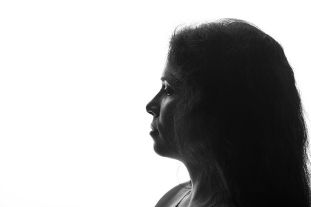 Portrait of a young woman looking up - horizontal silhouette on white backgroundの写真素材