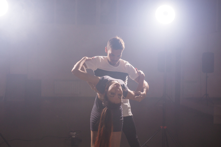 Young couple dancing social danse kizomba or bachata or semba or taraxia in dancing class backgroundの写真素材