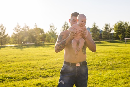 Father and baby son playing on field natureの写真素材