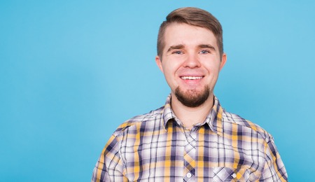 Portrait of a handsome young man against blue background with copyspaceの写真素材