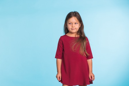 Sweet little girl over blue background with copyspaceの写真素材