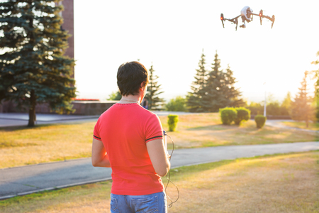 Man Operating Drone Flying or Hovering by Remote Control in Nature.の写真素材