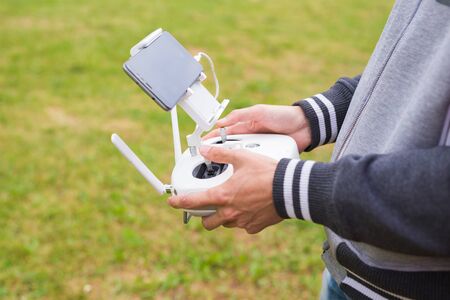 Ufa, Russia. - 6 June 2016 : Man Operating Drone Flying or Hovering by Remote Control in Nature