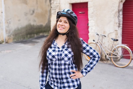 Young woman posing on the street bicycle backgroundの写真素材