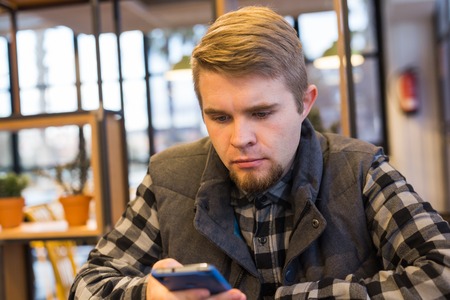 Serious man saw something in the smartphoneの写真素材