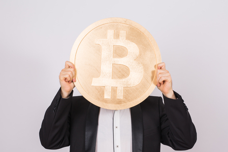 Man holding bitcoin on white backgroundの写真素材
