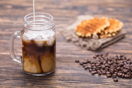 Milk is poured into coffeeの写真素材