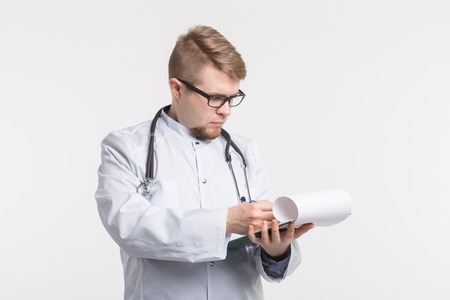 Medical doctor writing prescription over white background.