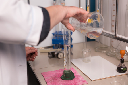 Lab technician doing chemical analysis. Testing chemical composition of the water.の写真素材