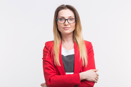 Portrait of young freckled woman wearing glasses against white backgroundの写真素材