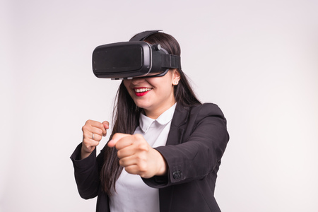 Happy excited young woman using a virtual reality headset on white background