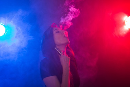 young woman smoking electronic cigaretteの写真素材