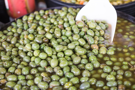 With the help of this spatula, the seller will impose on you olivesの写真素材