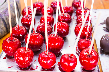 Red apples on a stick in caramel yum yumの写真素材