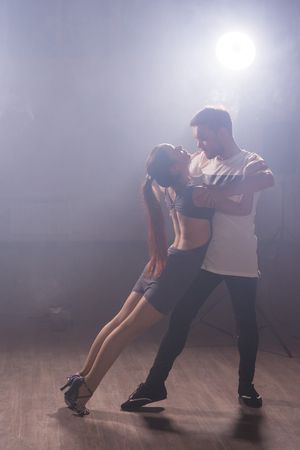 Active happy adults dancing bachata together in dance classの写真素材