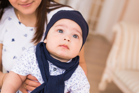 Young mother with cute baby at homeの写真素材