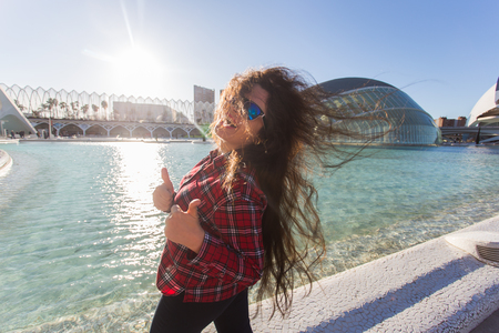 Valencia, Spain, January, 01, 2018, Happy woman standing on the background of the Hemisferic building in City of Arts and Sciences in Valencia, Spain.のeditorial素材