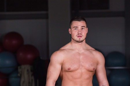 Portrait of muscular mixed race man in gymの写真素材