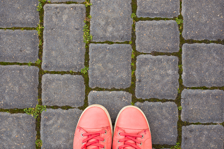 On the paving stones are red sneakers, top viewの写真素材