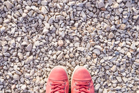 Red sneakers on pebbles, top viewの写真素材