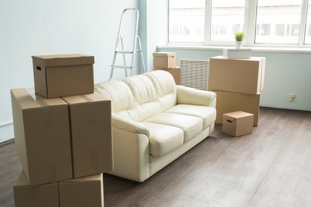 Light room with sofa and boxes which is prepared for moving.の写真素材